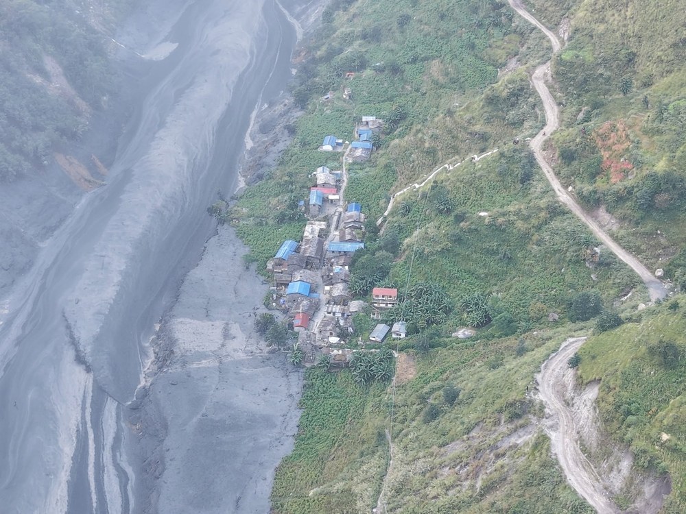 Flooded, debris-choked waters of the Budhi Gandaki river scouring through narrow rocky gorges in northern Gorkha following an upstream breach
